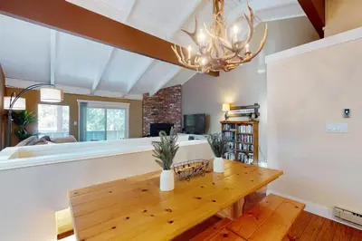 a dining room with a wooden table and a chandelier at Brown Bear's Hideaway in Incline Village