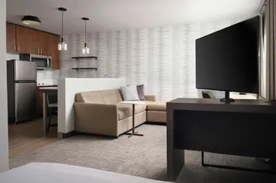a living room with a couch and a table with a tv at Residence Inn by Marriott Reno South in Reno