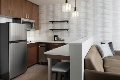 a kitchen with a stainless steel refrigerator and a couch at Residence Inn by Marriott Reno South in Reno