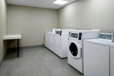 a laundry room with white washing machines and a counter at Residence Inn by Marriott Reno South in Reno