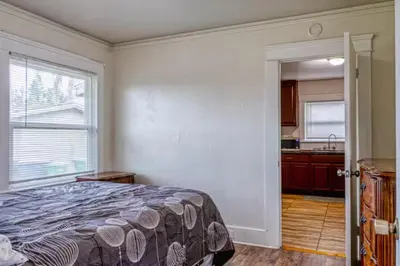 a bedroom with a bed and a kitchen at 2BR Family Getaway with Yard Kitchen and Parking in Lodi