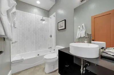 a white bathroom with a sink and a toilet at Hanford House in Sutter Creek