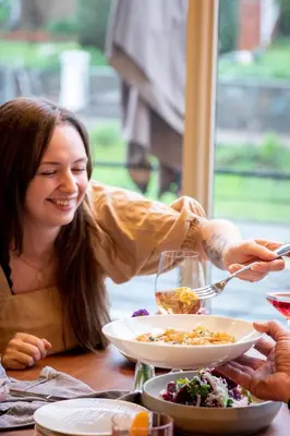 a woman sitting at a table with a plate of food at Hanford House in Sutter Creek