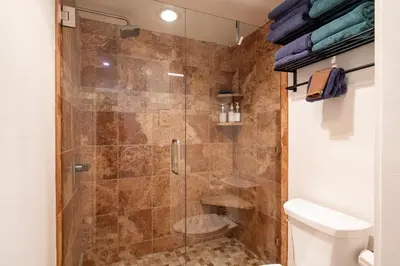 a shower with a glass door in a bathroom at Lux Retreat, Covered Parking, Walk to Golf in Mammoth Lakes