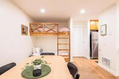 a room with a table and chairs and a bunk bed at Lux Retreat, Covered Parking, Walk to Golf in Mammoth Lakes