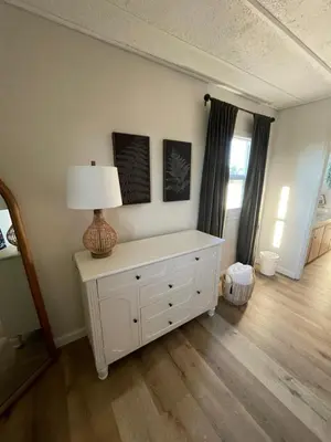 a room with a white dresser with a lamp on it at Scenic Ranch Retreat Near Fresno in Fresno