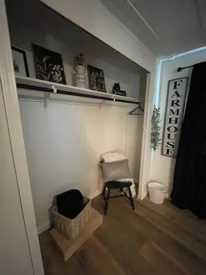 a living room with a chair and a shelf at Scenic Ranch Retreat Near Fresno in Fresno