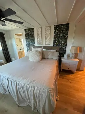 a bedroom with a large white bed with pillows at Scenic Ranch Retreat Near Fresno in Fresno
