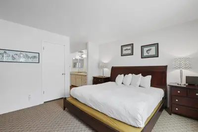 a bedroom with a large white bed and a dresser at 3 Bedroom Kirkwood Condo – Base Camp condo in Kirkwood
