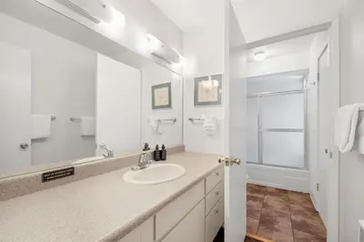 a white bathroom with a sink and a mirror at 3 Bedroom Kirkwood Condo – Base Camp condo in Kirkwood