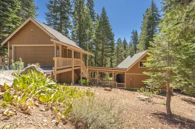 a house in the woods with a yard at Jester Court home in Tahoe Vista