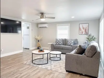 a living room with a couch and a table at Country Living 3BR with fenced yard on Mooney in Visalia