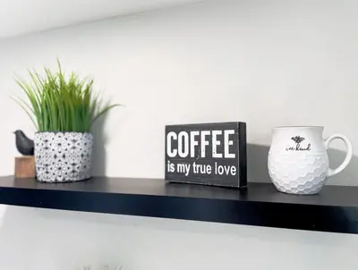 a black shelf with two vases and a coffee mug at Cozy Entire Home Gateway to Sequoia Pet Friendly in Visalia