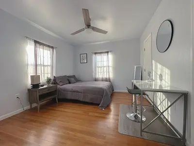 a bedroom with a bed and a ceiling fan at Sequoia Basecamp With Fenced Yard in Visalia