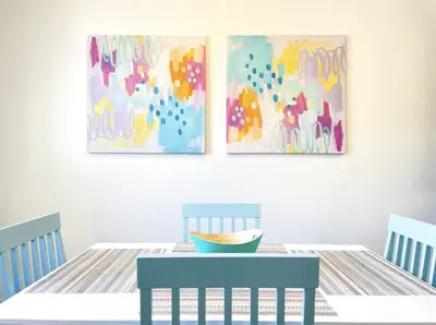 a dining room with a table and two paintings at Lovely home central Coalinga-2BR Stopover near I-5 in Coalinga