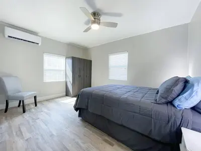 a bedroom with a bed and a ceiling fan at Ocean Breeze 2 bedroom w fenced yard on Mooney in Visalia