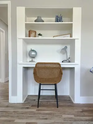 a chair sitting in a room with white shelves at Ocean Breeze 2 bedroom w fenced yard on Mooney in Visalia