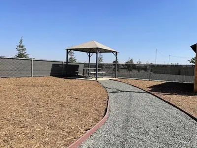 a walkway with a pavilion and a picnic table at Ocean Breeze 2 bedroom w fenced yard on Mooney in Visalia