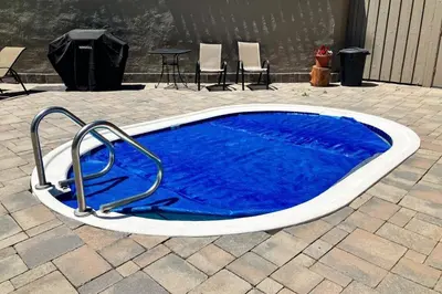 a pool with blue water in a patio at Sierra Megeve 16 in Mammoth Lakes
