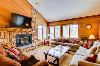 a living room with couches and a fireplace at Sierra Megeve 13 in Mammoth Lakes