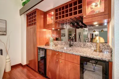 a kitchen with wooden cabinets and a counter top at Elegant Granite Bay Getaway Tall Pine Home in Granite Bay