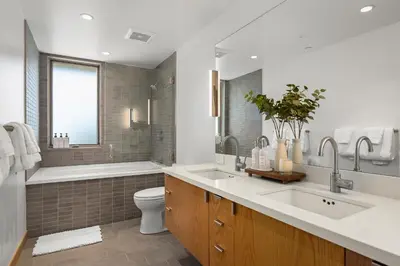 a bathroom with two sinks and a tub and a toilet at Northstar Ski-In Ski-Out Luxury Townhome with Hot Tub in Truckee