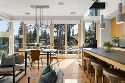 a kitchen and dining room with a table and chairs at Northstar Ski-In Ski-Out Luxury Townhome with Hot Tub in Truckee