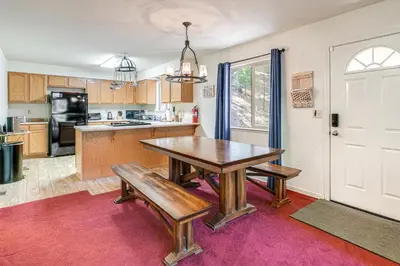 a kitchen with a wooden table and two benches at Hike, Swim, Golf Family Retreat in Arnold! in Arnold