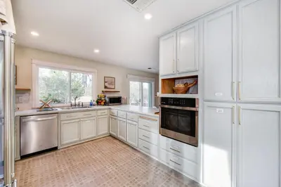 a large white kitchen with white cabinets and appliances at Gorgeous 4BR Home Massive Modern Home in Cameron Park