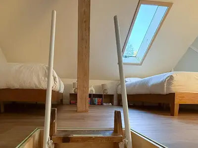 a attic room with two beds and a window at Walk to Lake 4BR Memory Making Alpine Retreat in Tahoe City