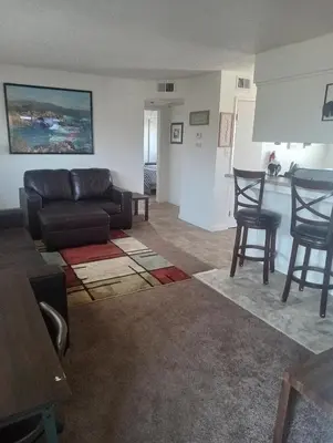 a living room with a couch and two chairs at Franklin Apt in Fresno