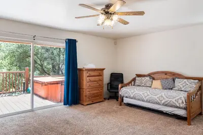 a bedroom with a bed and a ceiling fan at Groveland 2BR Home - Mountain Retreat in Groveland