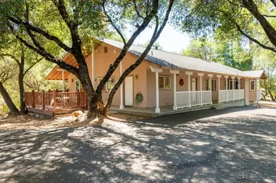 a house with a tree in front of it at Groveland 2BR Home - Mountain Retreat in Groveland