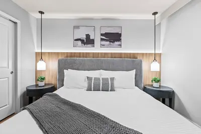 a bedroom with a large bed with two night stands at NEW 10BD At Windsor Cay Pool and Game Room