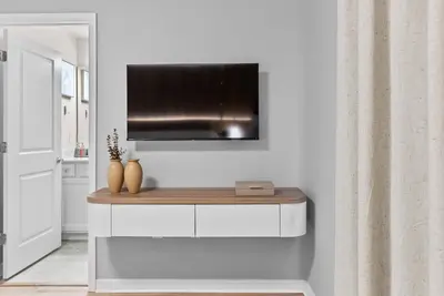 a living room with a television on a wall at NEW 10BD At Windsor Cay Pool and Game Room