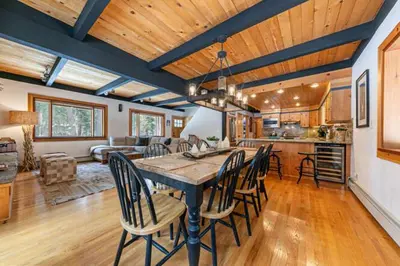 a dining room and kitchen with a table and chairs at Lakewalk Lodge at the West Shore by Tahoe Getaways, Pet-Friendly w Sauna! in Homewood