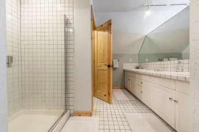 a bathroom with a tub and a sink and a shower at Lakewalk Lodge at the West Shore by Tahoe Getaways, Pet-Friendly w Sauna! in Homewood