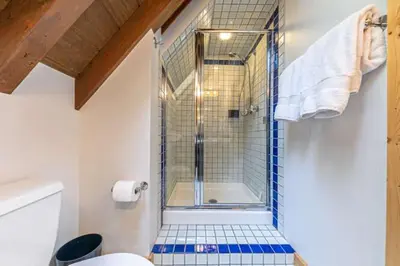 a bathroom with a shower with a glass door at Lakewalk Lodge at the West Shore by Tahoe Getaways, Pet-Friendly w Sauna! in Homewood