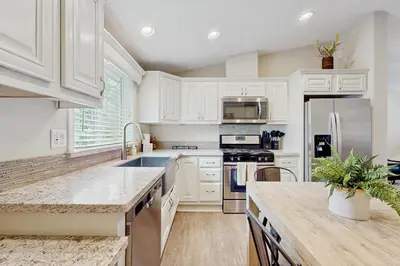 a kitchen with white cabinets and a counter top at Sierra Solace in South Lake Tahoe