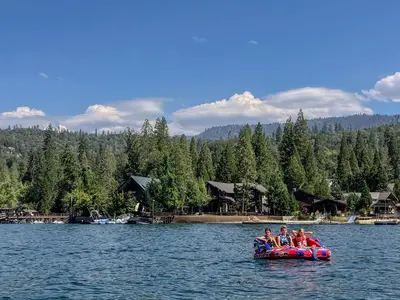 a group of people riding on a raft on a lake at Enchanting Creekside Cabin Retreat near Yosemite National Park in California in Oakhurst