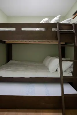 two bunk beds in a room with white pillows at Buckeye Basecamp-Events-Family Friendly-Creek in Sonora