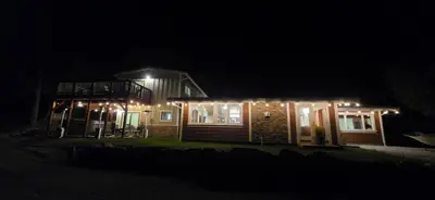 a house lit up at night with lights on it at Buckeye Basecamp-Events-Family Friendly-Creek in Sonora