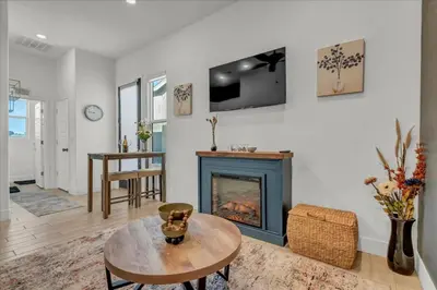 a living room with a fireplace and a table at Peaceful Guest Casita with Private Entrance and No Cleaning Fee in Hanford