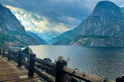 a wooden bridge over a lake with mountains at Paradise Place in Groveland