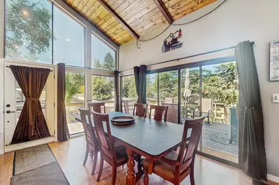 a dining room with a table and chairs and windows at Paradise Place in Groveland