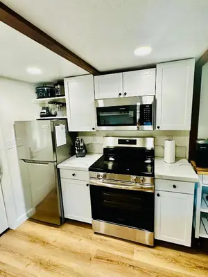 a kitchen with a stove and a refrigerator at The Falls-Overlooks a waterfall-BBQ-Sleeps 4 in Oakhurst