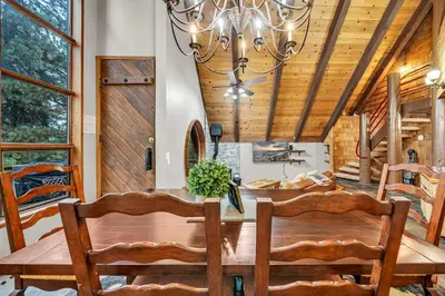a dining room with a wooden ceiling and a chandelier at Peaceful Getaway Pet Friendly with Hot Tub and Grill in Tahoe City