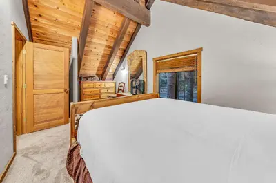 a bedroom with a large bed and wooden ceilings at Peaceful Getaway Pet Friendly with Hot Tub and Grill in Tahoe City