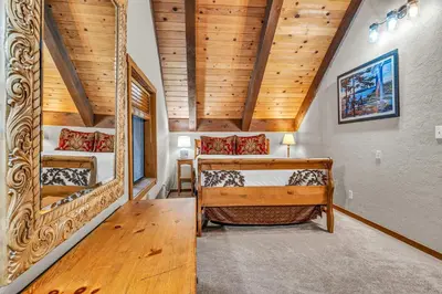 a bedroom with two bunk beds and a wooden ceiling at Peaceful Getaway Pet Friendly with Hot Tub and Grill in Tahoe City