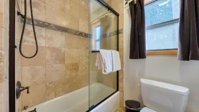 a bathroom with a shower and a toilet at Cozy Escape w Hot Tub Deck Access to Tahoe Donner Skiing Alpenglow Chalet by AvantStay in Truckee